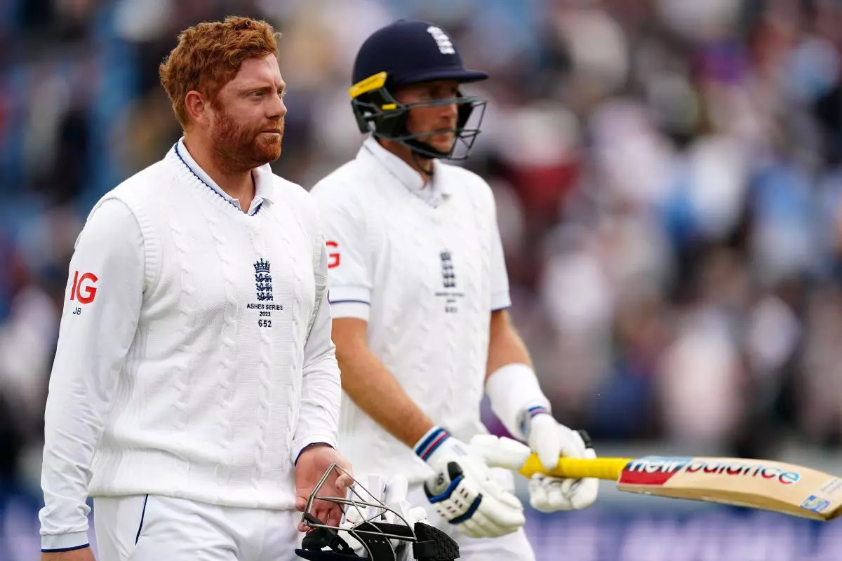 England's Jonny Bairstow (left) and England's Joe Root leave the field