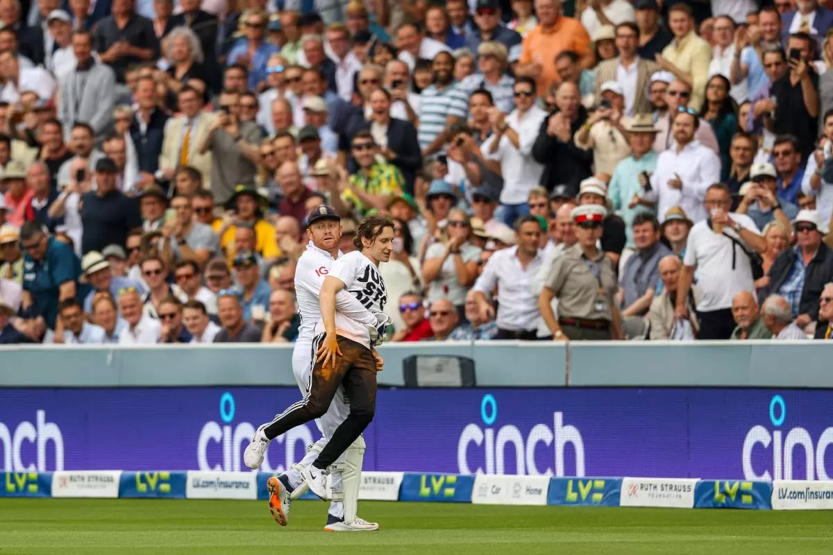 England's Jonny Bairstow removes a Just Stop Oil protester during the Ashes second test at London - June 2023