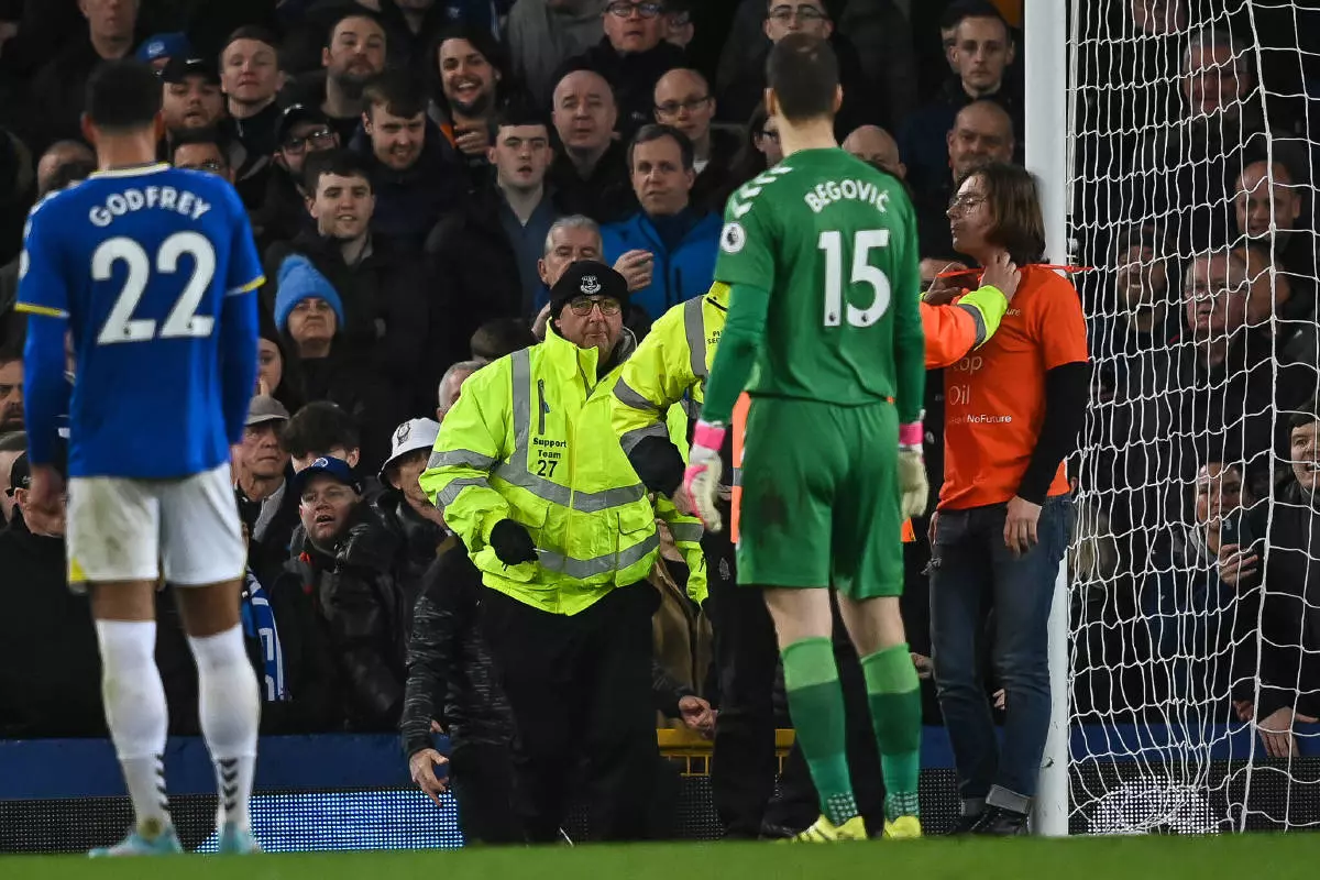 Protester ties himself to the Everton goalpost