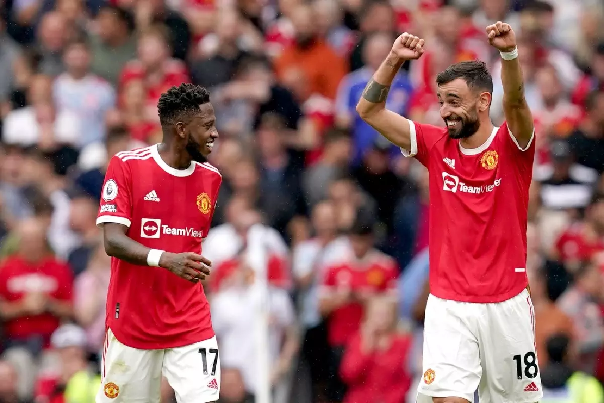 Manchester United's Bruno Fernandes celebrates his opening-day Premier League hat-trick against Leeds with Fred in August 2021