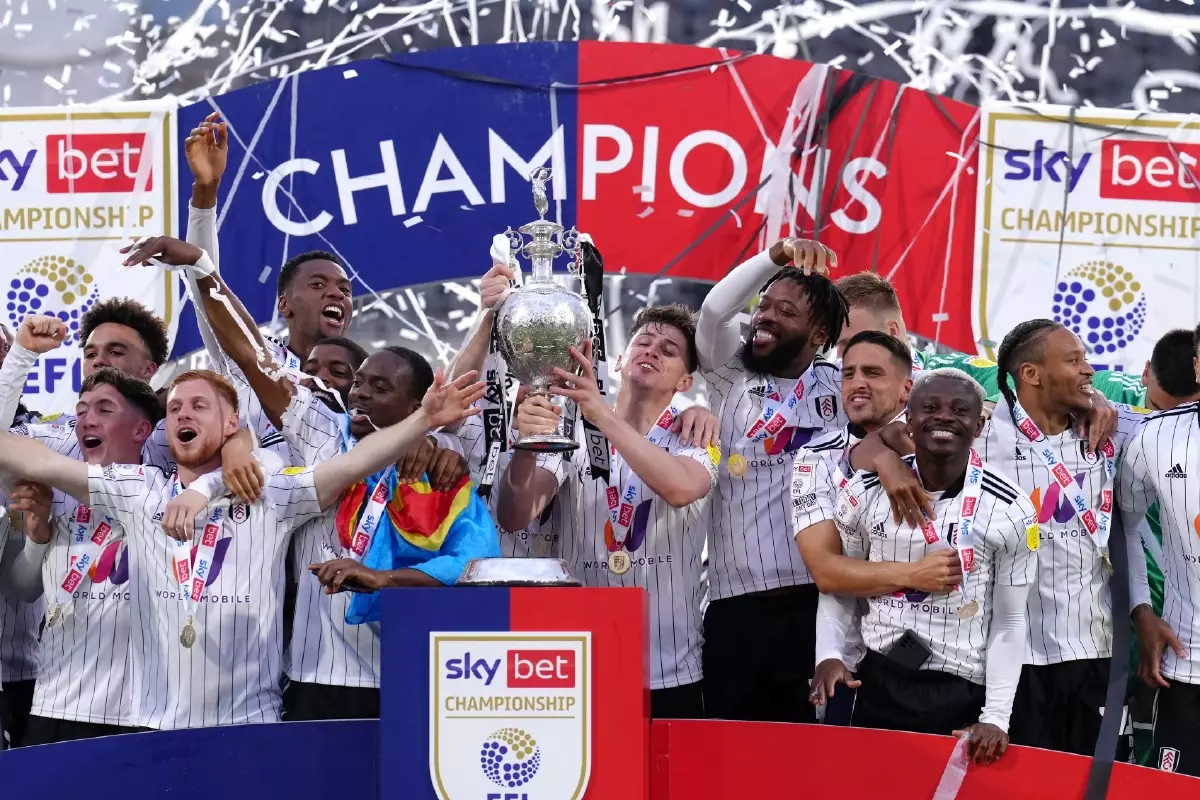 Fulham celebrate winning the Championship by lifting the trophy in May 2022
