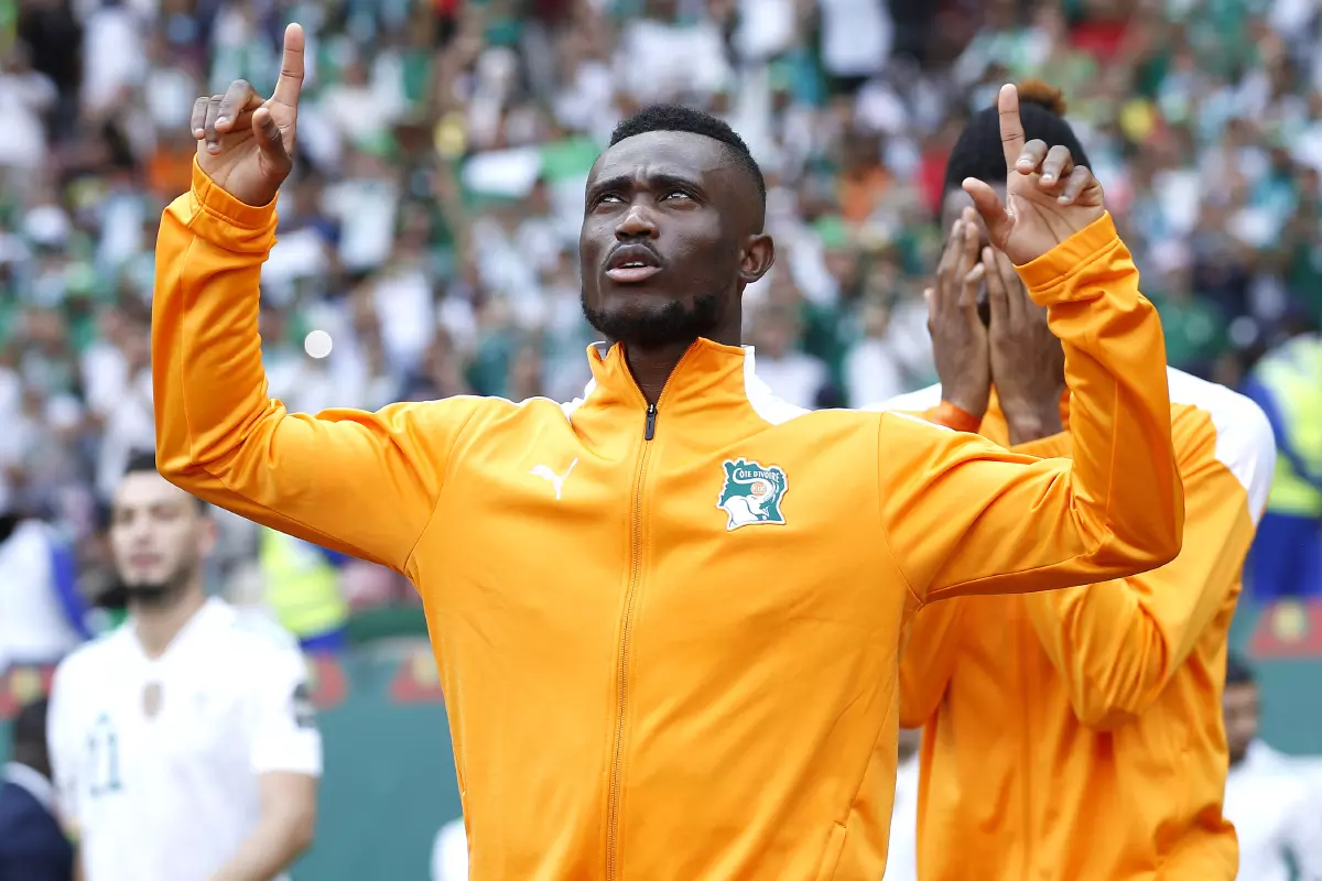 Ghislain Konan of Ivory Coast walks out with his team