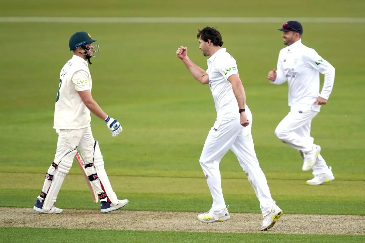Hampshire's James Fuller (centre) celebrates to catch of Nottinghamshire's Joe Clarke (left) by team-mate Ben Brown - April 2023