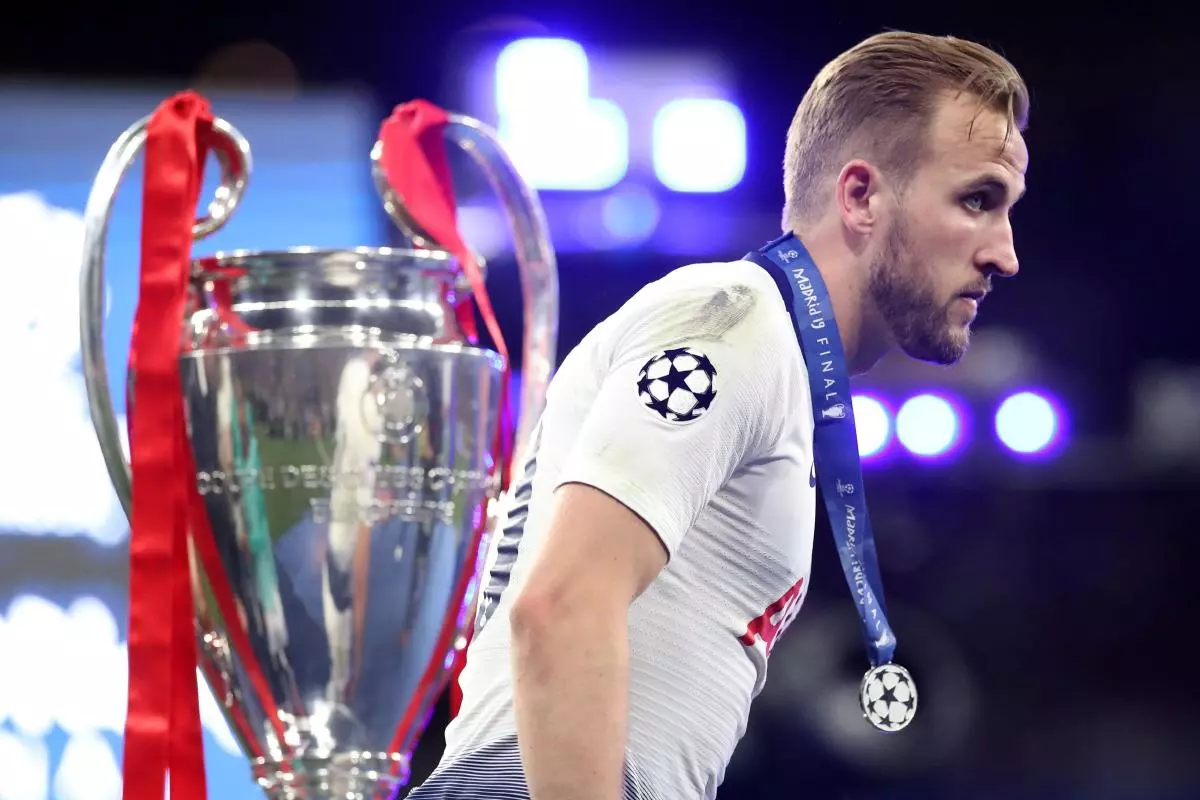 Tottenham's Harry Kane walks past the trophy