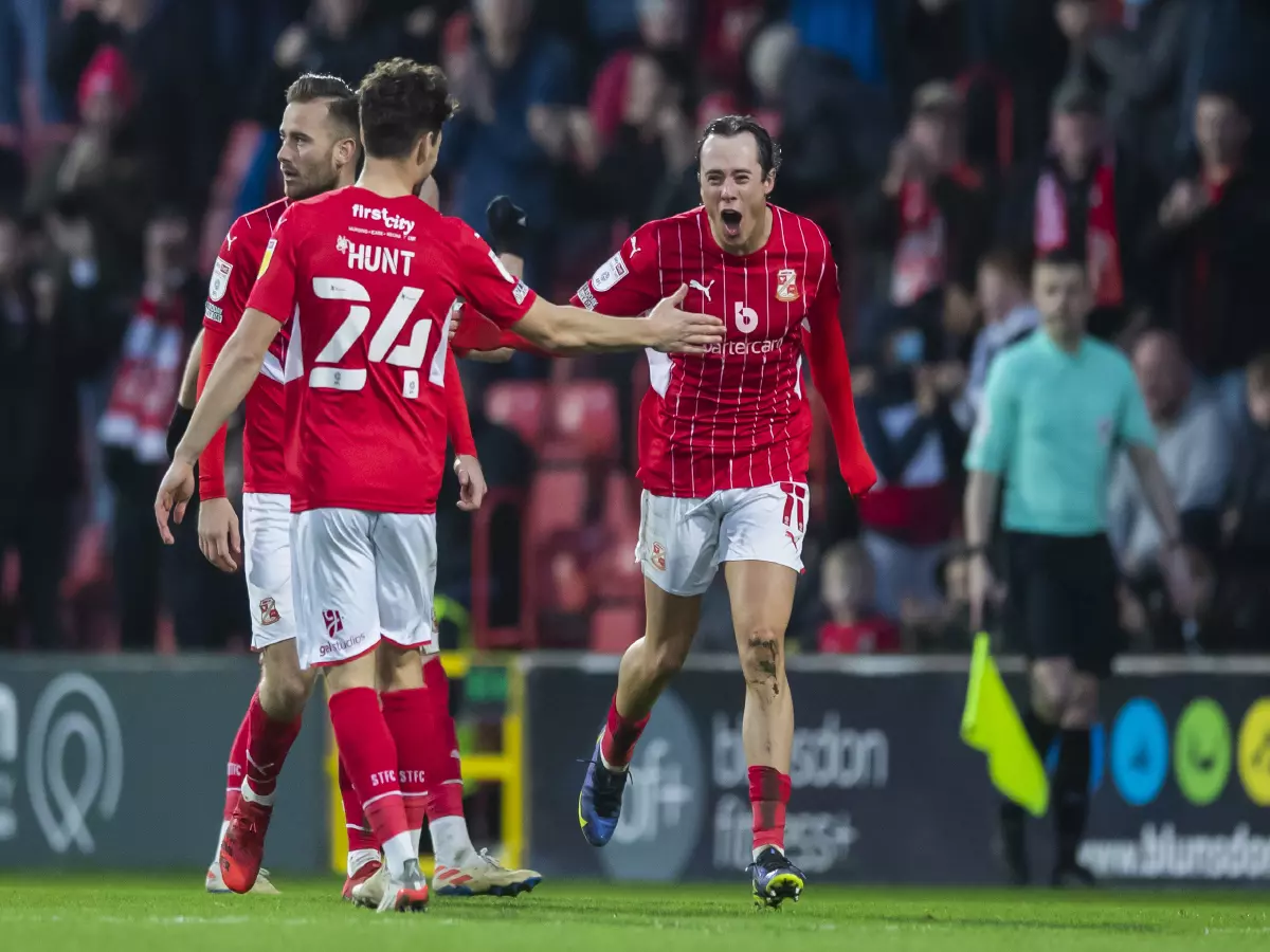 Harry McKirdy celebrates scoring four goals for Swindon Town