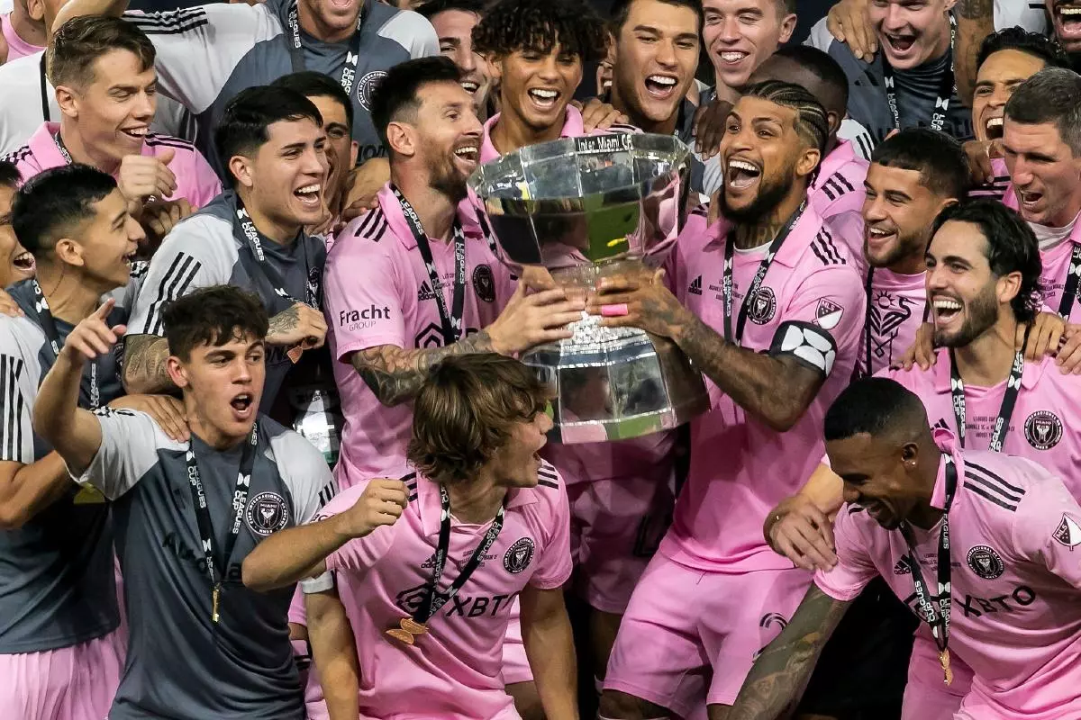 Inter Miami forward Lionel Messi with DeAndre Yedlin and teammates prepare to lift the Leagues Cup trophy