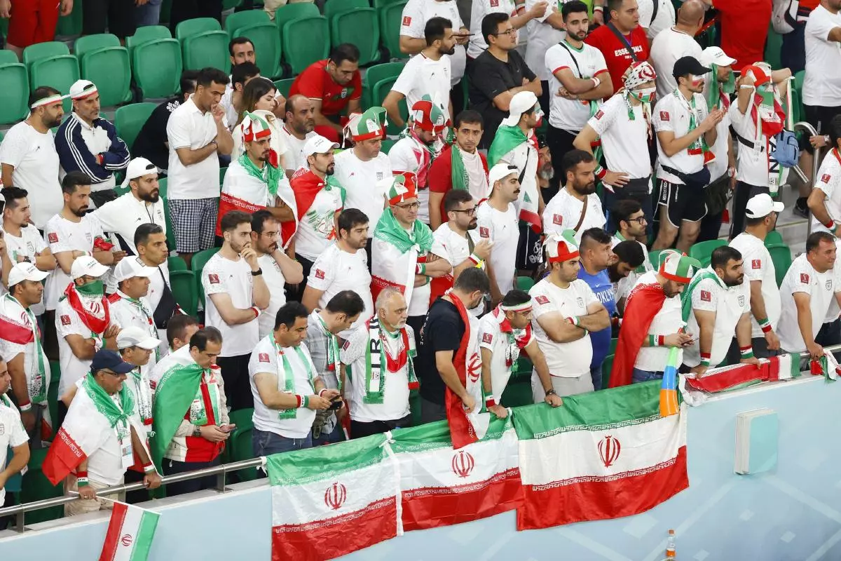 Iran supporters look dejected after Iran failed to qualify for the World Cup Round of 16