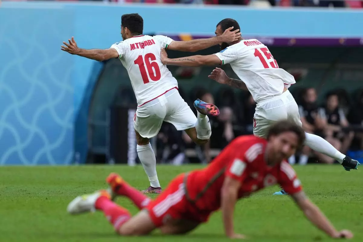 Iran's Roozbeh Cheshmi (right) celebrates scoring their side's first goal of the game during the FIFA World Cup Group B