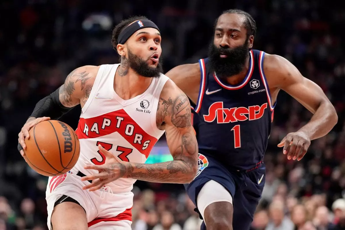 Toronto Raptors guard Gary Trent Jr. (33) looks to the basket under pressure from Philadelphia 76ers guard James Harden