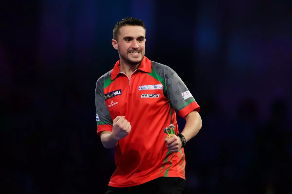 Jamie Lewis celebrates during his match against Daryl Gurney during day ten of the William Hill World Darts Championships at Alexandra Palace