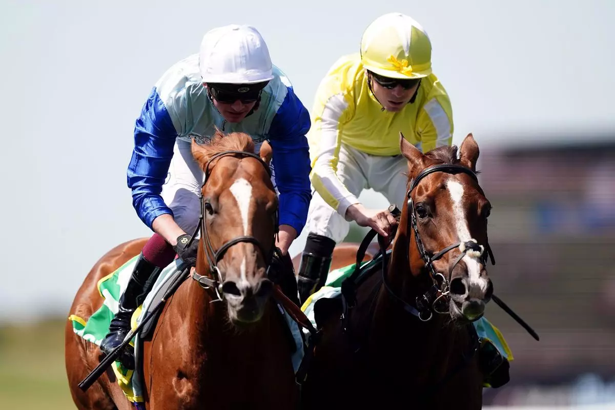 Jimi Hendrix ridden by jockey Rob Hornby (left) on their way to winning the bet365 Mile Handicap