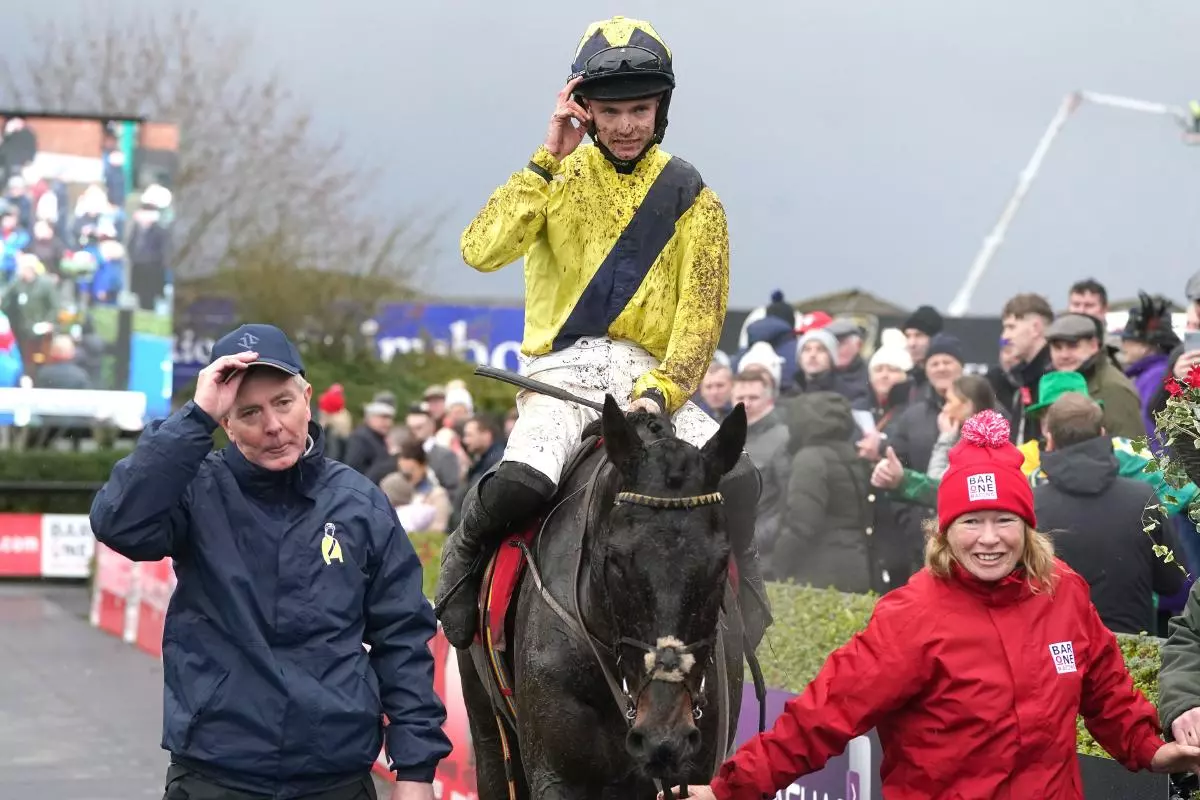 Jockey Michael O'Sullivan and trainer Barry Connell celebrate after winning the Bar One Racing Royal Bond Novice Hurdle with horse Marine Nationale