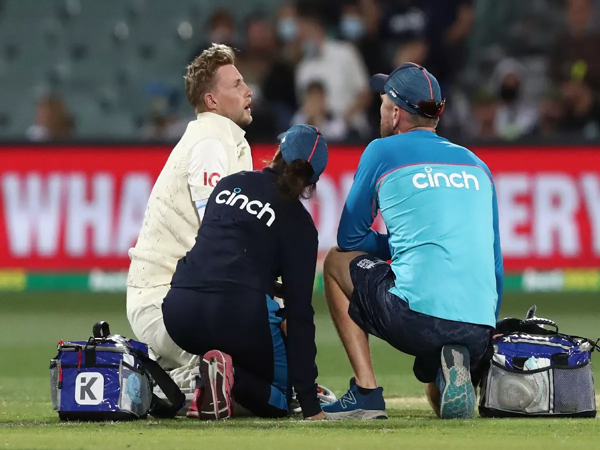 Joe Root speaks to medical staff after being struck in the groin during The Ashes