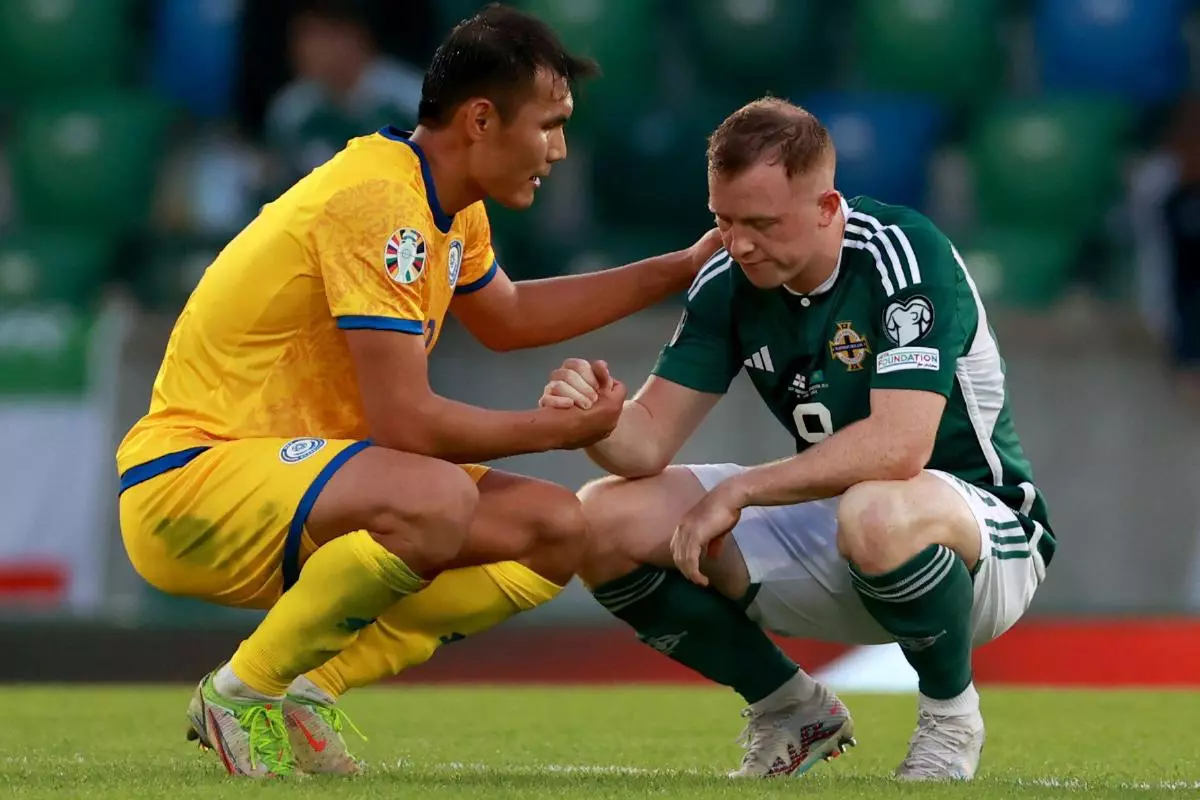 Kazakhstan’s Nuraly Alip commiserates Northern Ireland’s Shayne Lavery