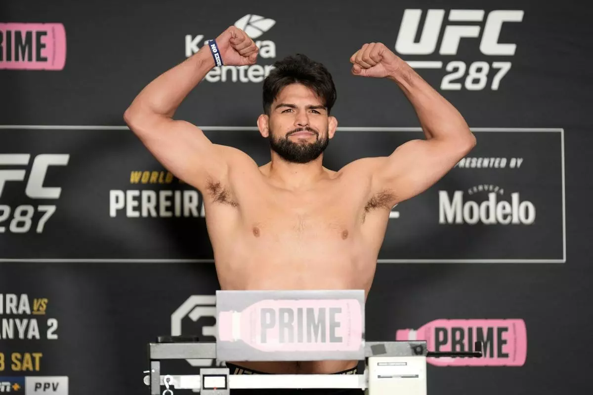 Kelvin Gastelum steps on the scale for the official weigh-ins at UFC287 - April 2023