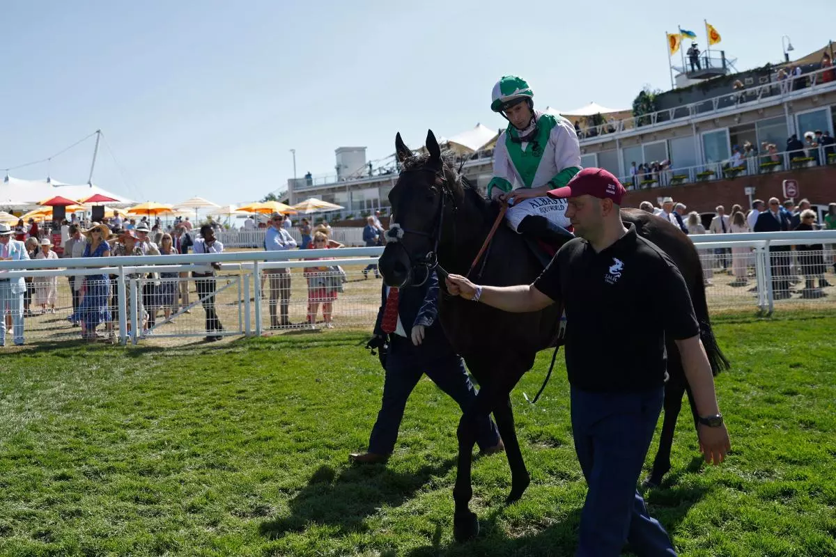 Khaadem ridden by jockey Ryan Moore after winning the King George Qatar Stakes