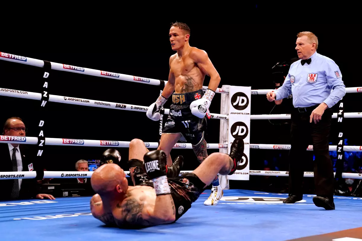 Kiko Martinez is knocked down during his IBF World Featherweight Title fight against Josh Warrington at the First Direct Arena, Leeds. Picture date: Saturday March 26, 2022.