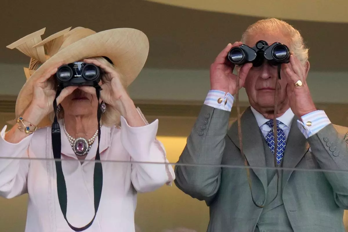King Charles III and Queen Camilla watch a race at Royal Ascot