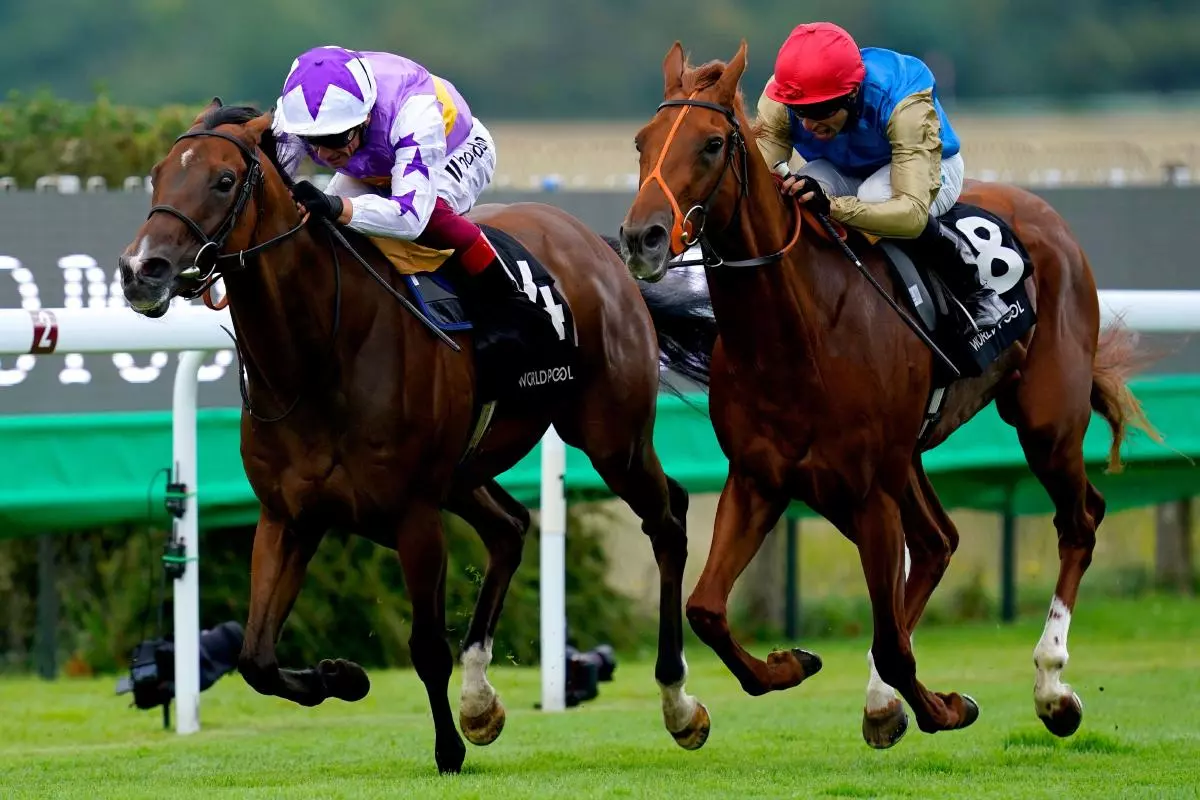 Kinross ridden by jockey Frankie Dettori (left) on their way to winning the Lennox Stakes at Goodwood