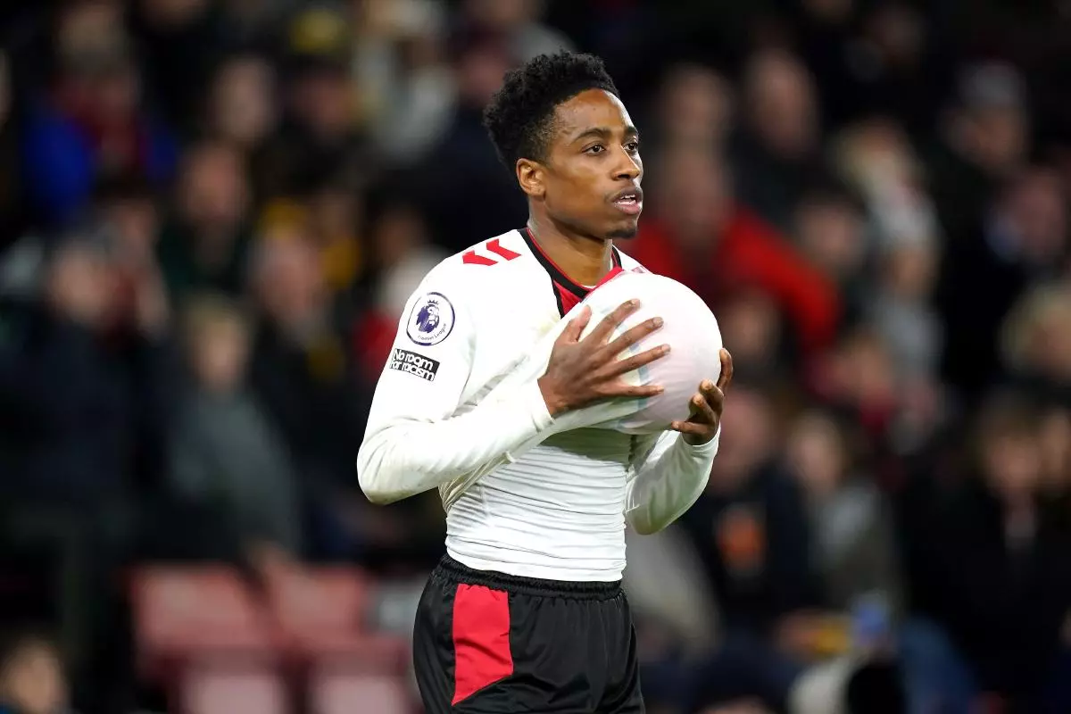 Kyle Walker-Peters cleans the ball before a throw in