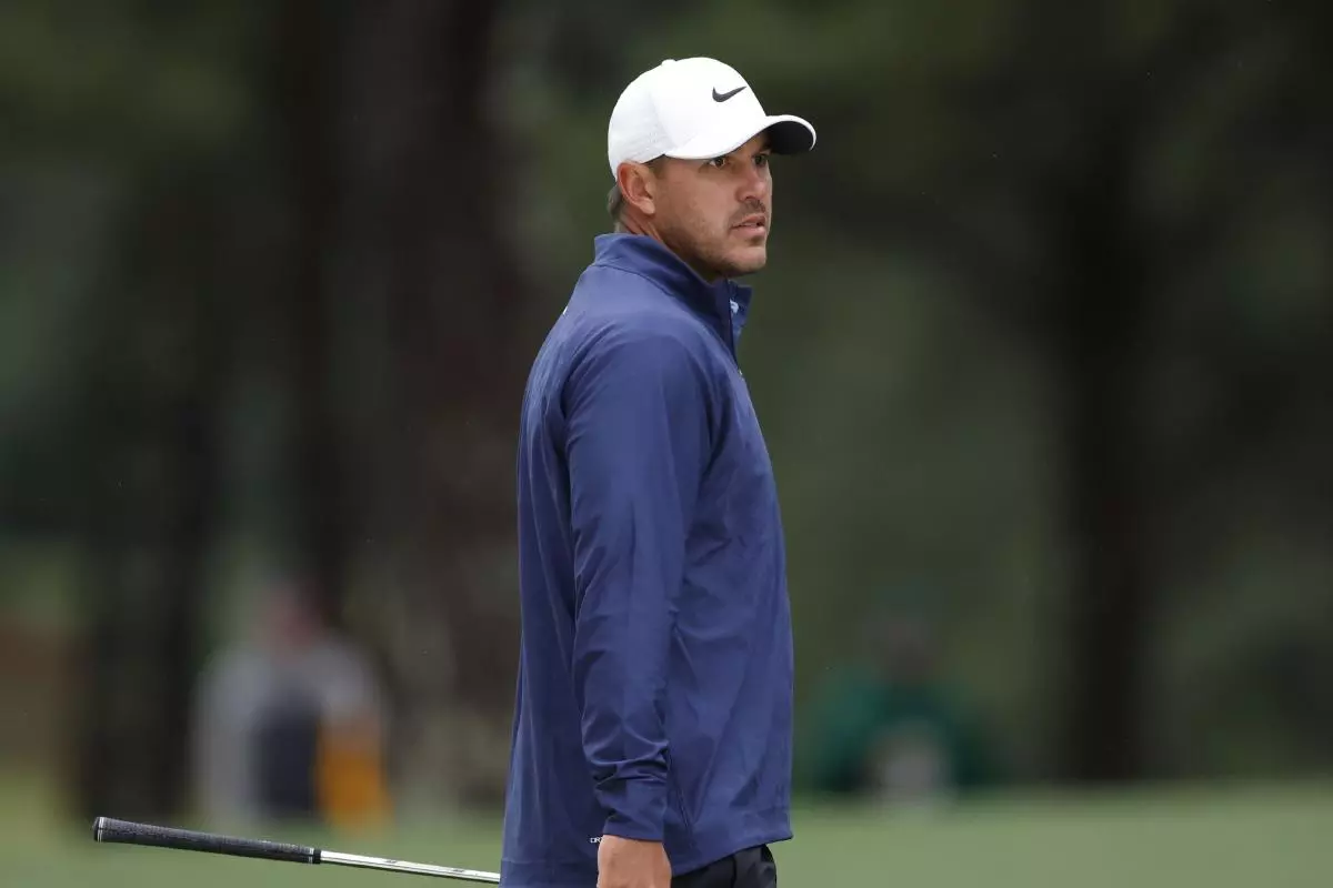 Leader Brooks Koepka looks at shot from a bunker to the first hole during the third round at the 87th Masters