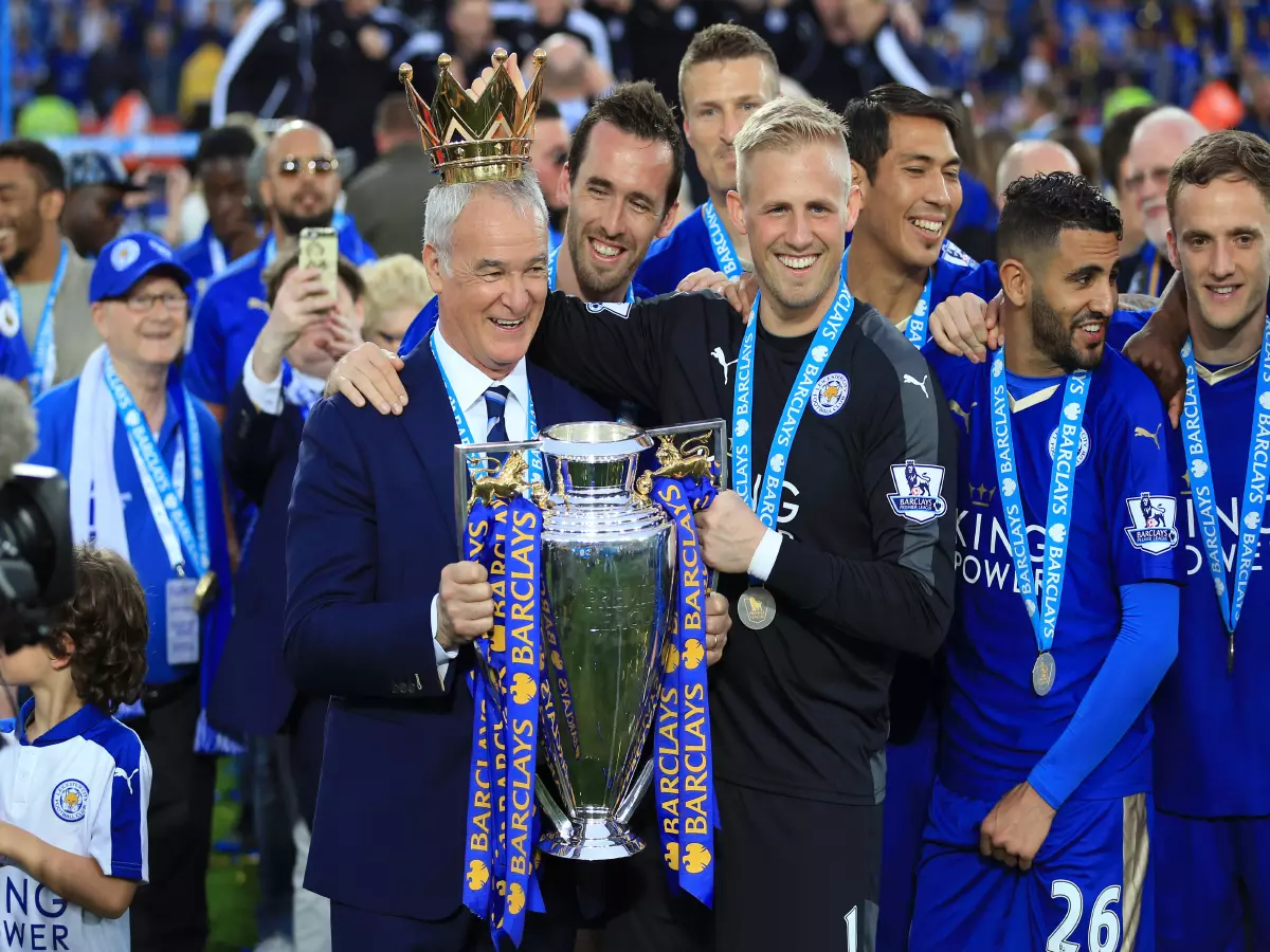 Leicester City manager Claudio Ranieri and Kasper Schmeichel lifts the trophy as the team celebrate winning the Barclays Premier League, after the match at the King Power Stadium