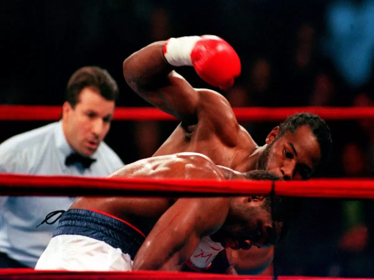 Lennox Lewis lands a heavy right on Michael Grant