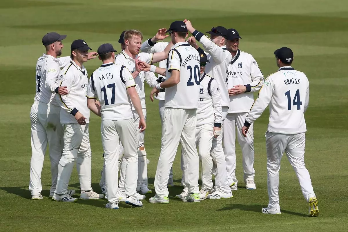 Liam Norwell of Warwickshire celebrates with his team-mates
