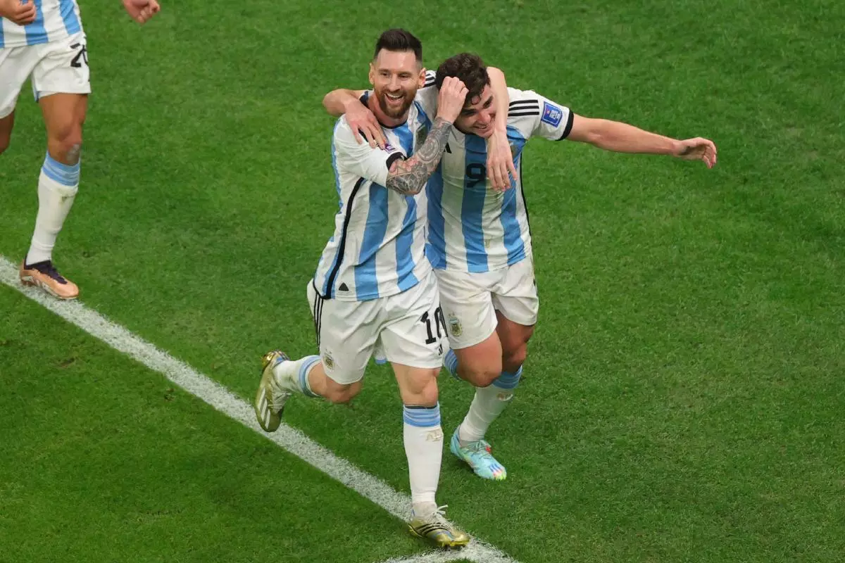 Julian Alvarez of Argentina scores a goal and celebrates with Lionel Messi of Argentina