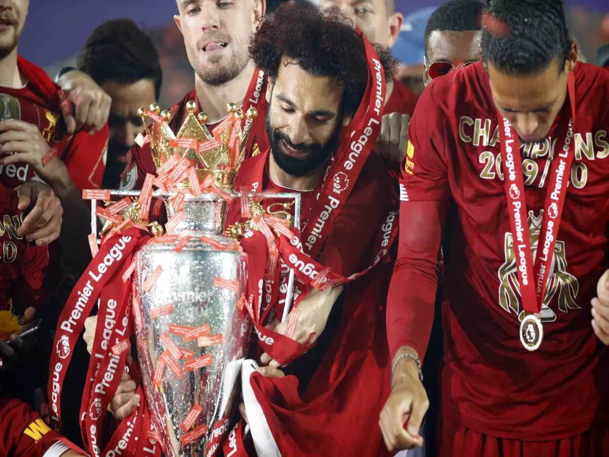 Liverpool's Mohamed Salah celebrates with the Premier League trophy after the Premier League match at Anfield, Liverpool.