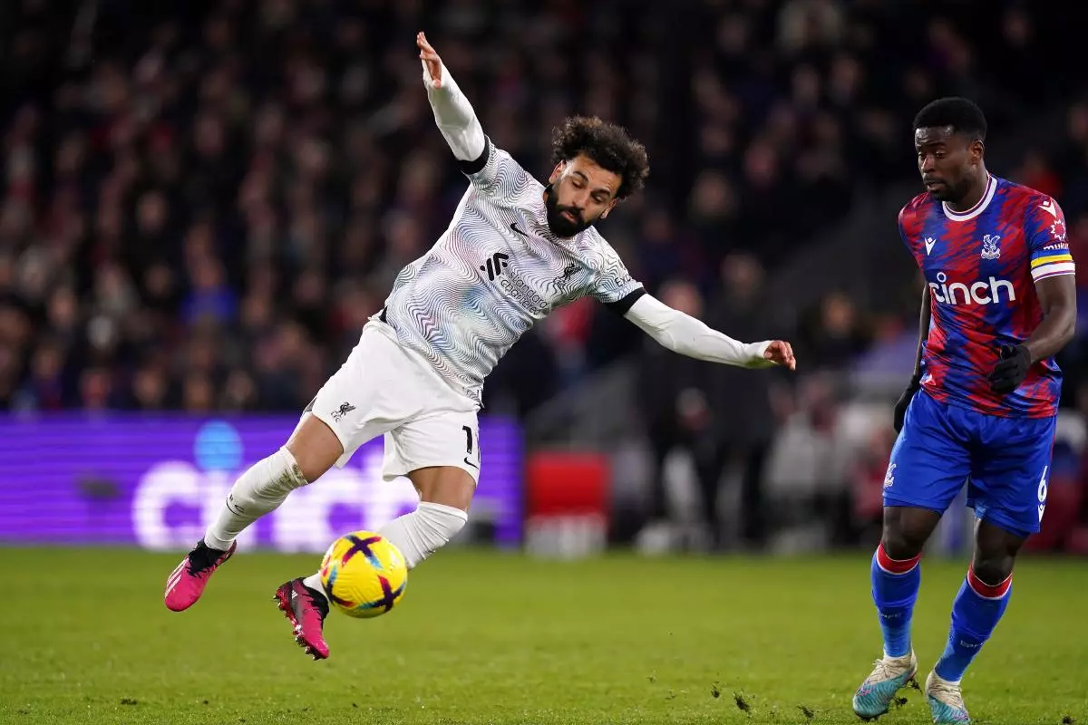 Liverpool's Mohamed Salah trips over