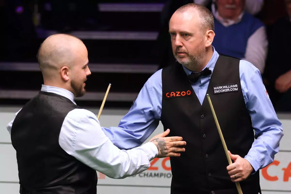 Luca Brecel (left) is congratulated by Mark Williams