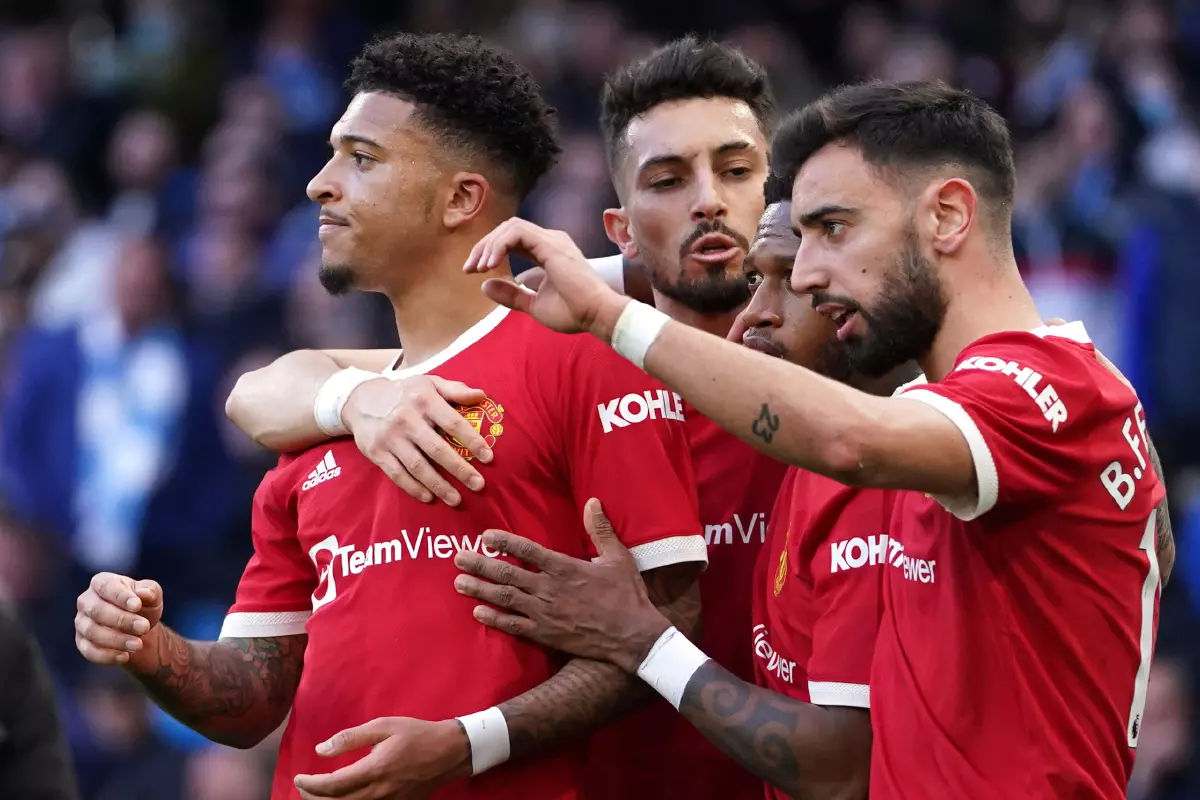 Manchester United's Jadon Sancho (left) celebrates scoring their side's first goal of the game during the Premier League match at the Etihad Stadium, Manchester.