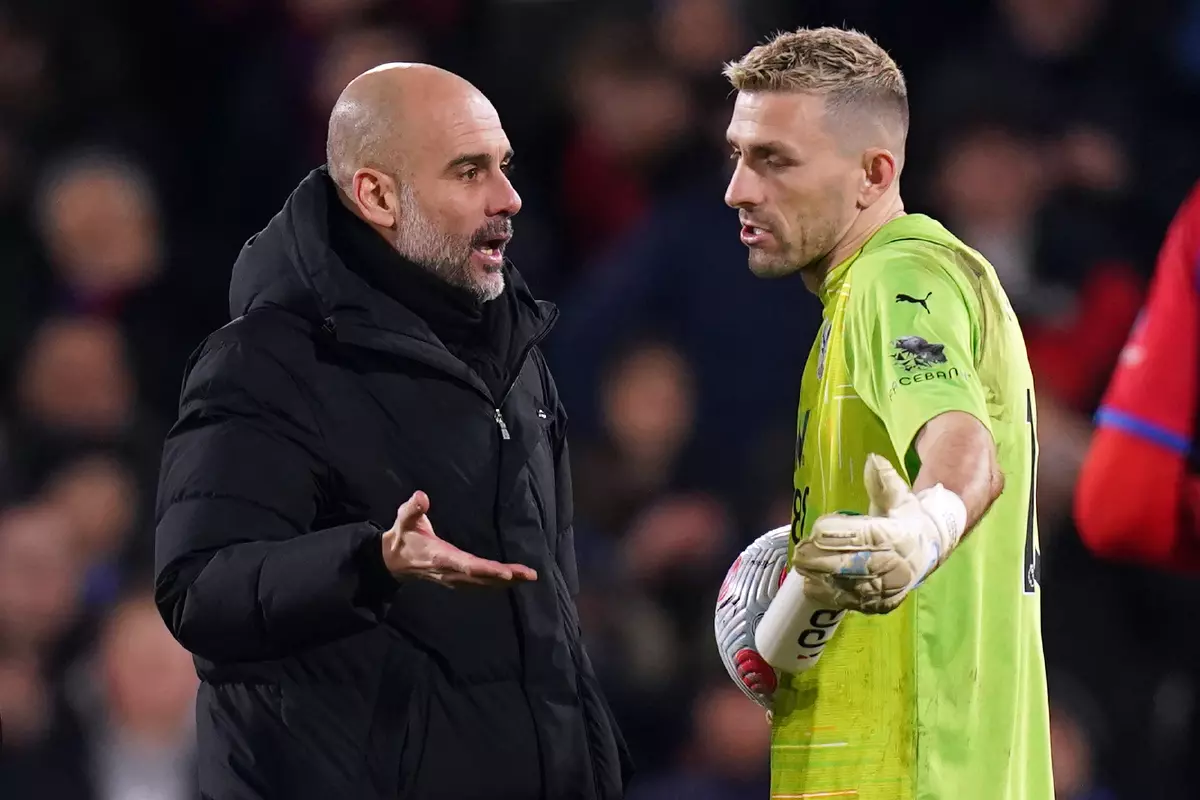 Manchester City manager Pep Guardiola (left) with Crystal Palace's goalkeeper Vicente Guaita following the Premier League match at Selhurst Park, London. Picture date: Monday March 14, 2022.