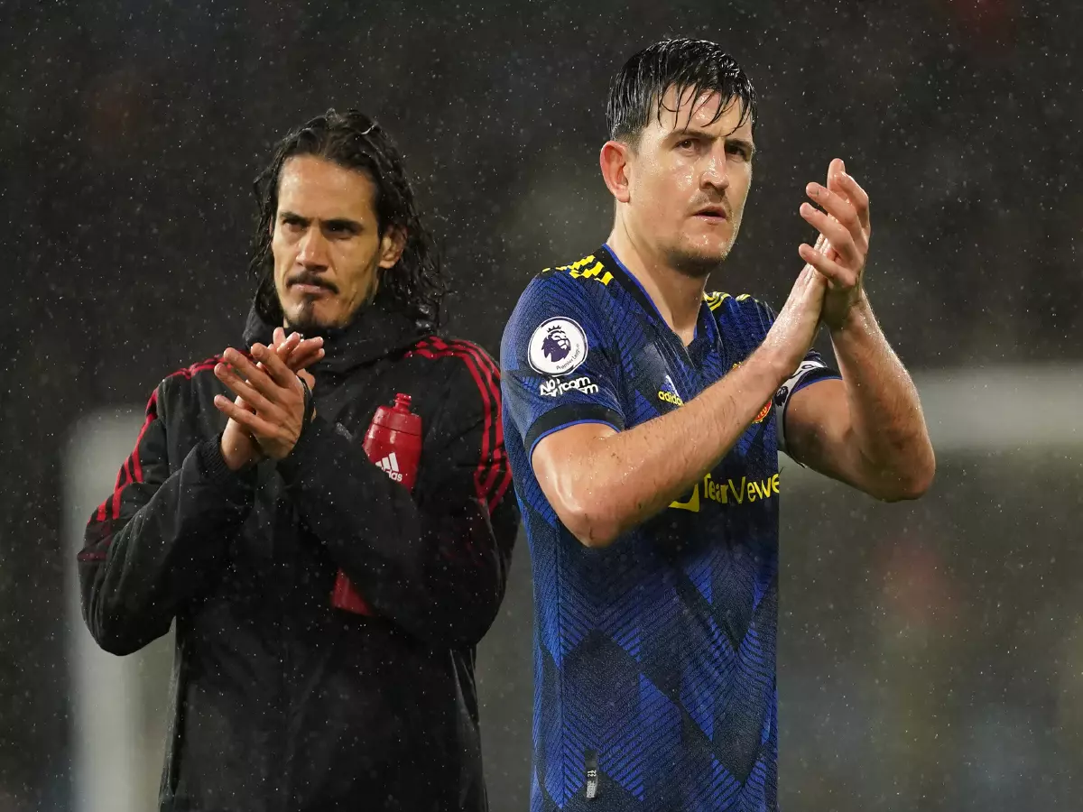 Manchester United's Harry Maguire (right) and Edinson Cavani appear dejected after the Premier League match at Turf Moor, Burnley. Picture date: Tuesday February 8, 2022.
