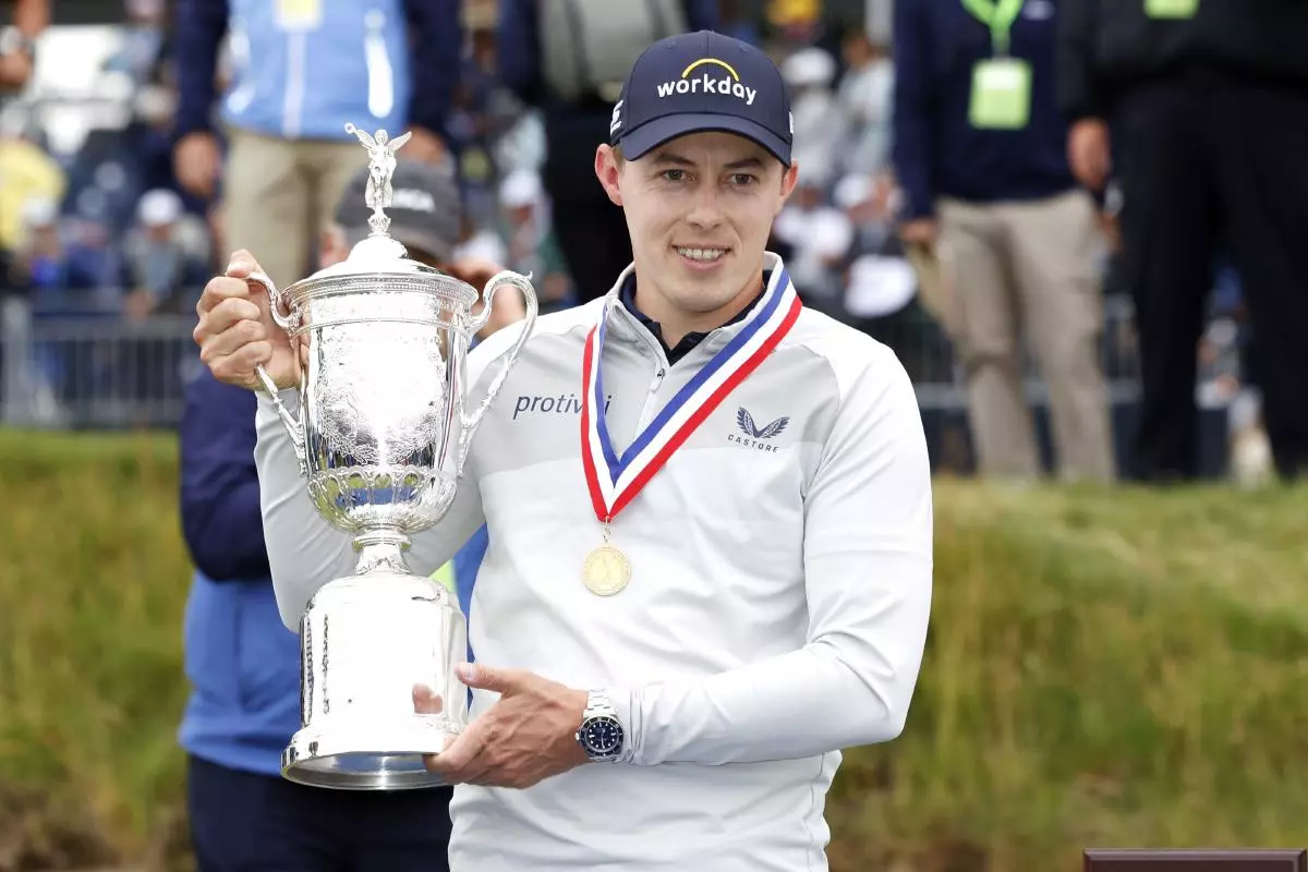 Matt Fitzpatrick of England holds the championship trophy