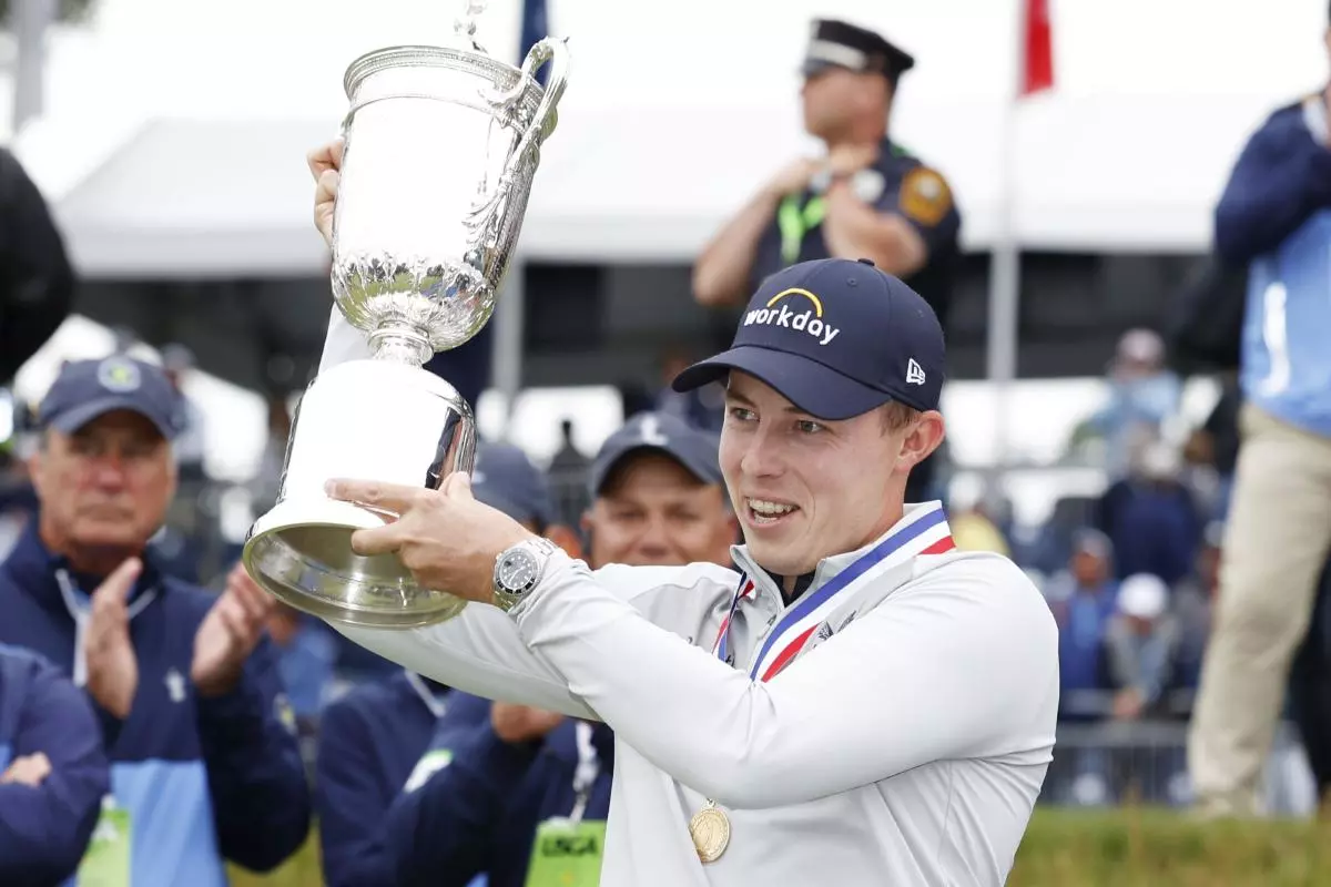 Matt Fitzpatrick of England holds the championship trophy