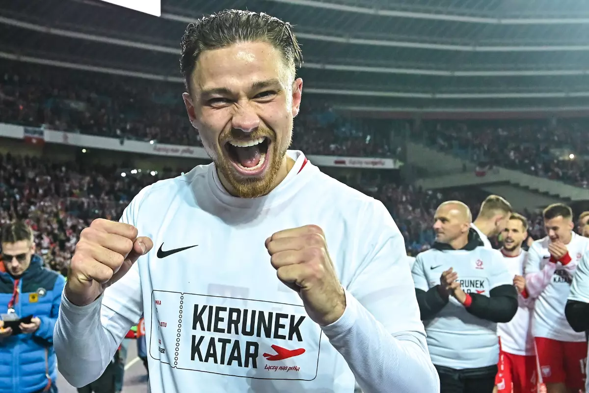 Matty Cash of Poland celebrates after winning the 2022 FIFA World Cup playoff qualifying football match