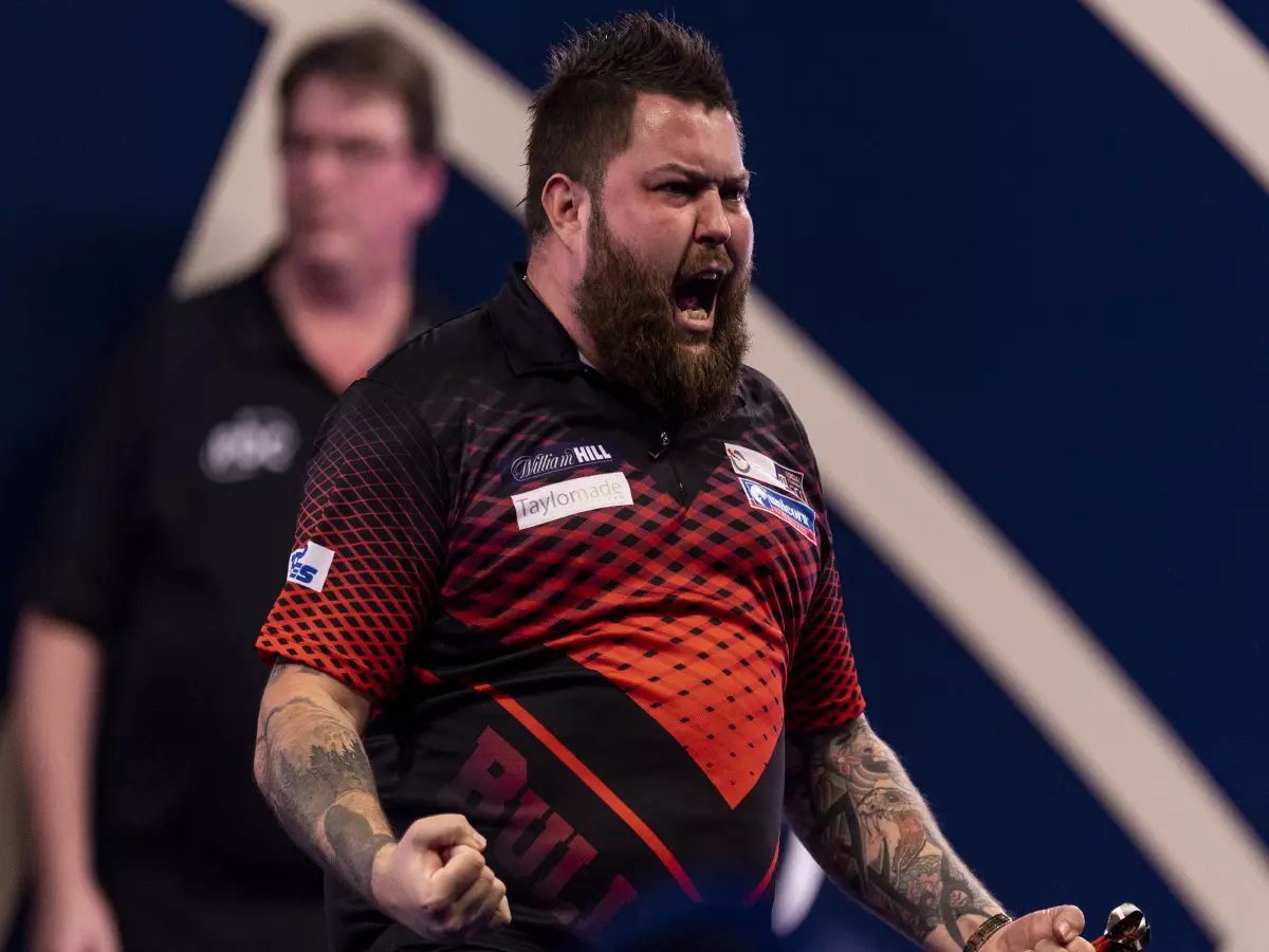 Micheal Smith celebrates beating Gerwyn Price during day fourteen of the William Hill World Darts Championship at Alexandra Palace, London. Picture date: Saturday January 1, 2022.