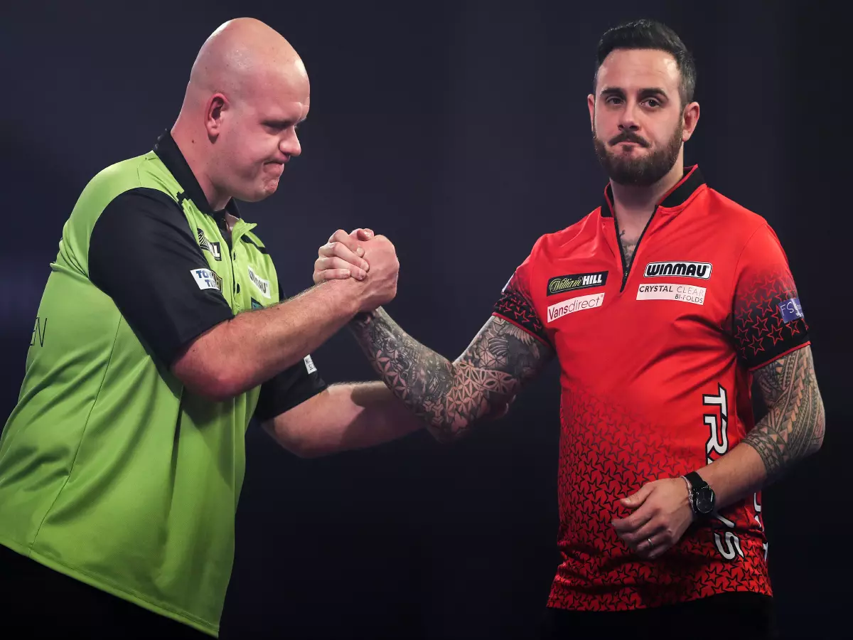 Michael van Gerwen (left) shakes hands with Joe Cullen (right) after winning the match during day twelve of the William Hill World Darts Championship at Alexandra Palace, London.