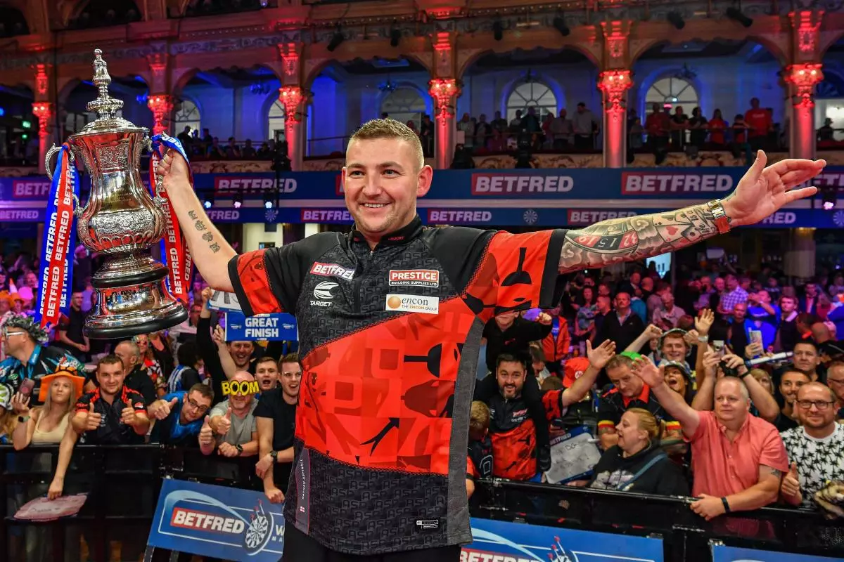 Nathan Aspinall holds the trophy in front of the fans after winning the World Matchplay - July 2023
