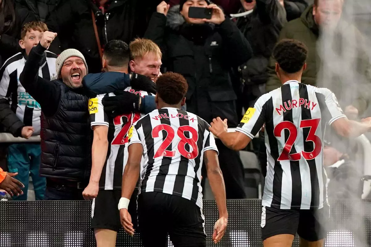 Newcastle United's Miguel Almiron celebrates with the fans after scoring