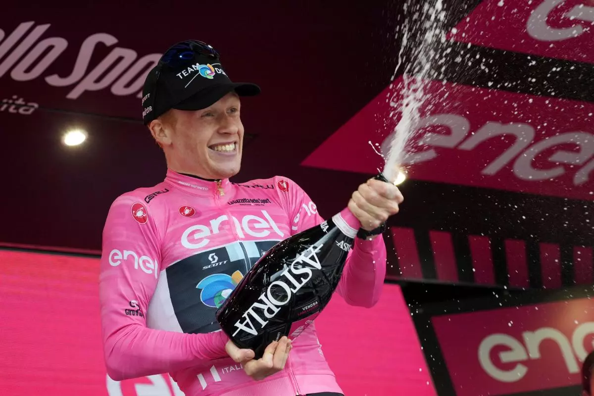 Norway's Andreas Leknessund celebrates taking the leader’s pink jersey
