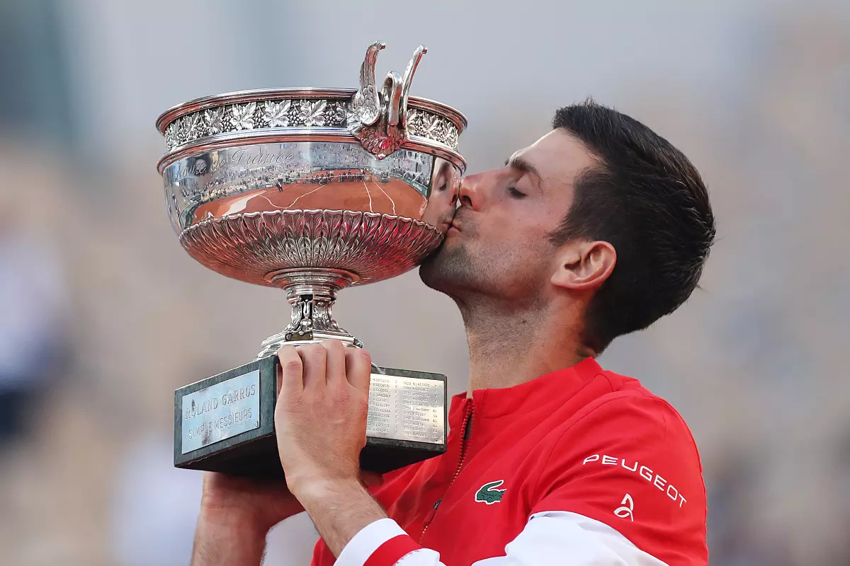 Novak Djokovic of Serbia kisses the trophy after winning the Men's Singles finals match against Stefanos Tsitsipas of Greece at the French Open tennis tournament at Roland Garros in Paris, Fr