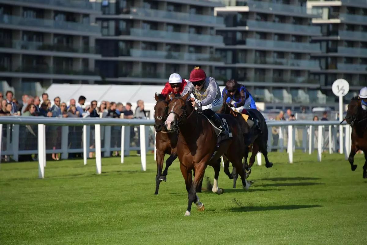 Pat Dobbs hits the front before winning the 18.40 KKA Studio Novice Stakes on Baheer at Newbury - July 2023