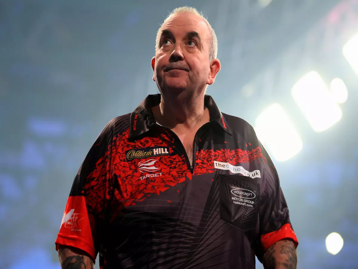Phil Taylor reacting during day fifteen of the William Hill World Darts Championship at Alexandra Palace, London.