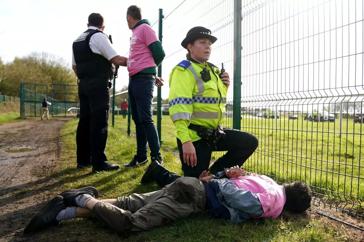 Protesters are detained by police during day three of the Randox Grand National Festival