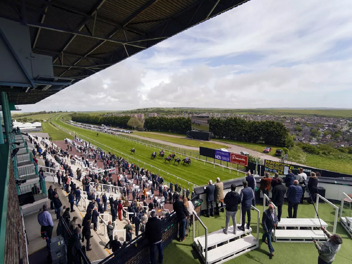 Racegoers watch the action at Brighton Racecourse.