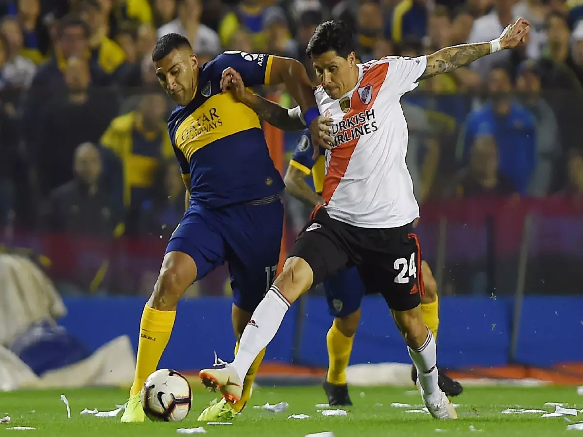 Ramon Abila of Boca Juniors and Enzo Perez of River Plate
