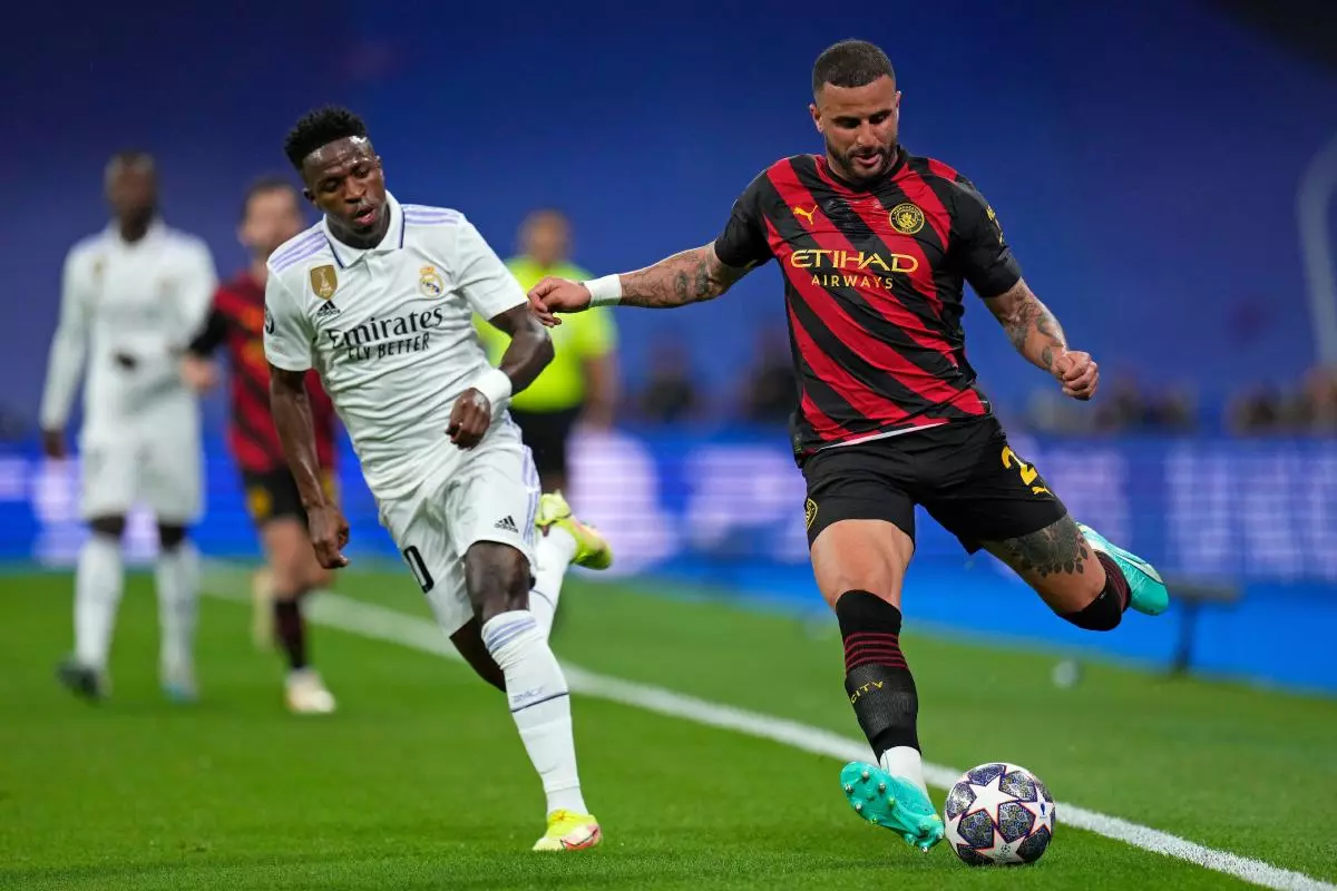 Real Madrid's Vinicius Junior, left, chases Manchester City's Kyle Walker